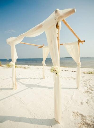 Bamboo Chuppah with sheer off white linen and small flower accents
