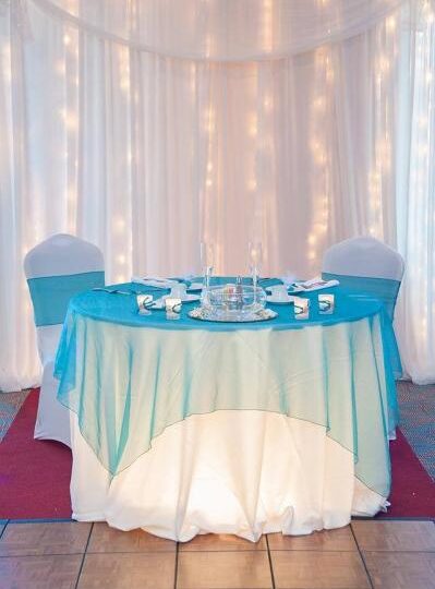 Bridal Table wall back lit with twinkle lights.