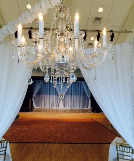 Chandelier over round chuppah