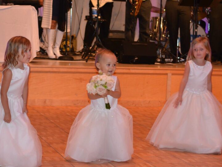 Flower girls in white dresses at a Pensacola wedding reception