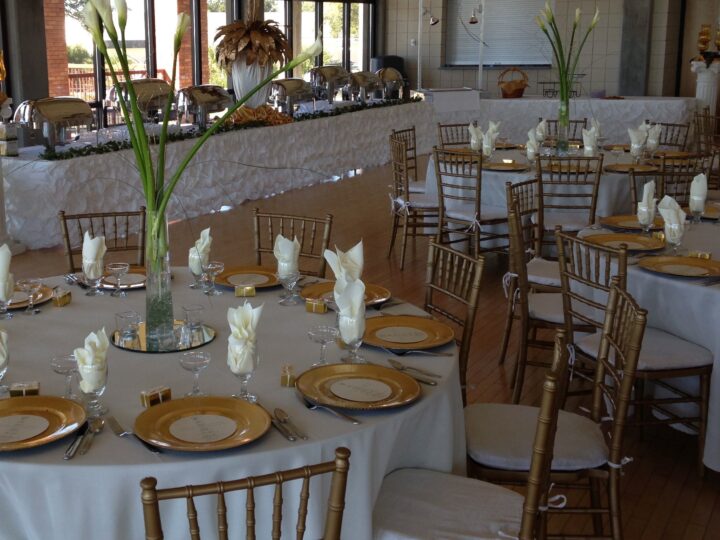 Gold Chiavari chairs and gold chargers at a wedding reception