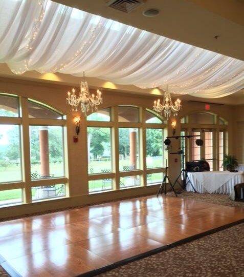 Lighted drapes with Chandeliers over Oak Dance Floor at Scenic Hills Country Club