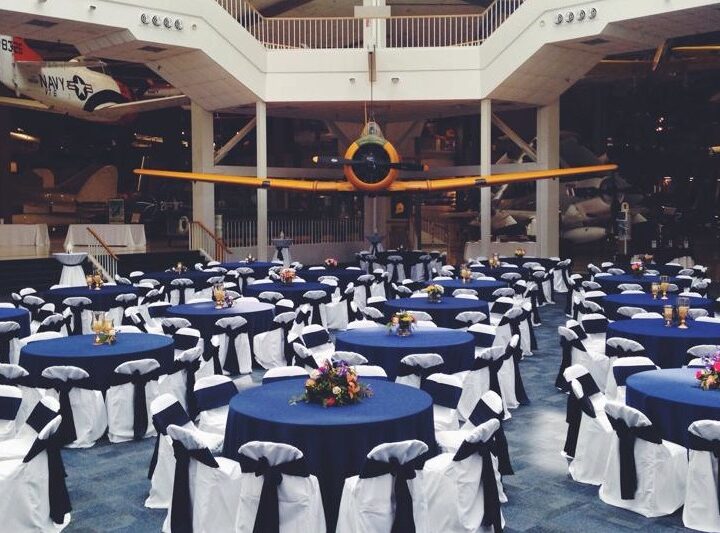 Navy blue linens and white chair covers at the National Naval Aviation Museum
