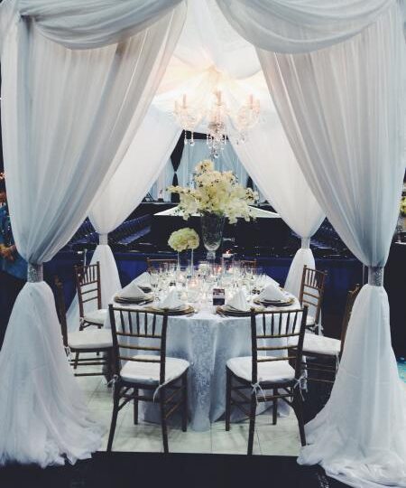 Round Chuppah dressed with White Draping and our gorgeous glimmering Chandelier