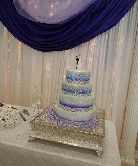 Wedding Drapery Wall Placing a wedding drapery behind your cake table adds a classy look.