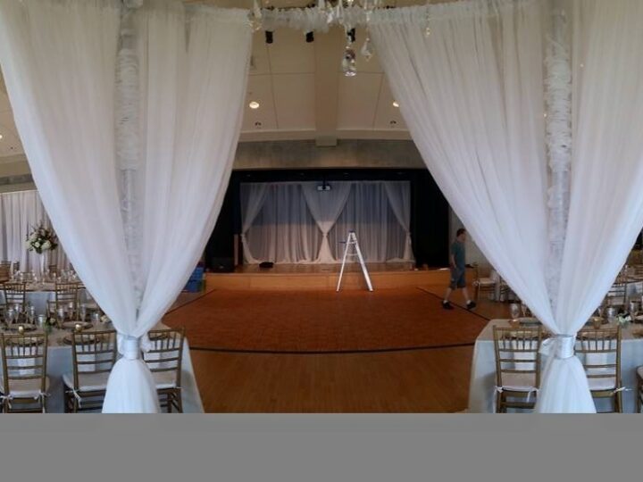 White draping frames the stage at Sanders Beach Community Center